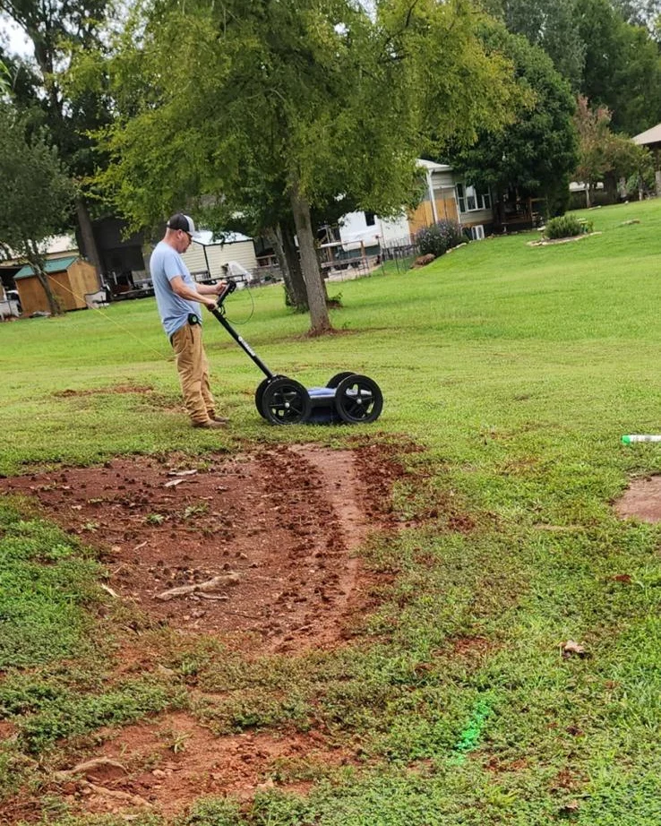 Carolina Septic technician scanning a backyard with a ground penetrating radar cart before digging